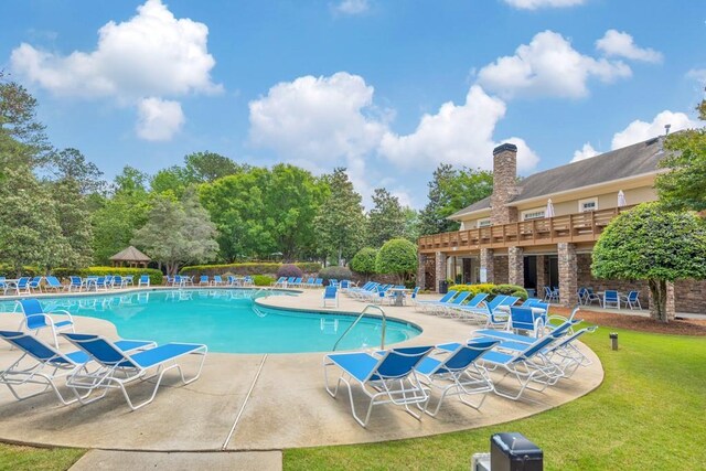 community pool featuring a patio area and a yard