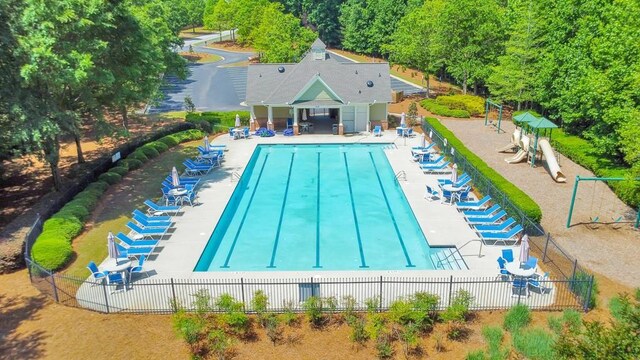 community pool featuring fence and a patio