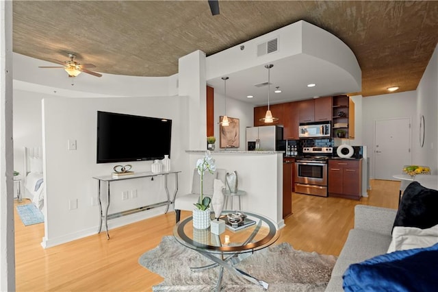 living room featuring light wood-type flooring and ceiling fan