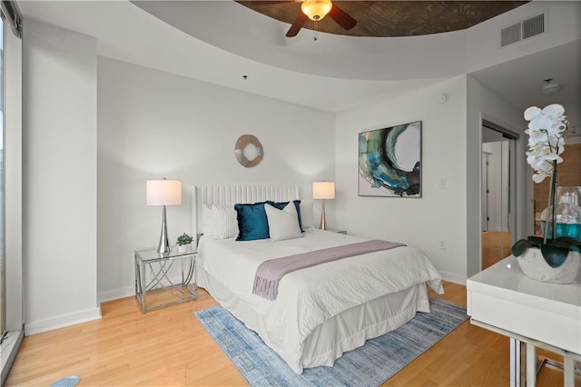 bedroom with hardwood / wood-style floors and ceiling fan