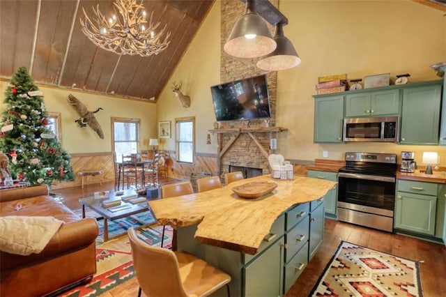 kitchen featuring green cabinets, appliances with stainless steel finishes, dark wood-type flooring, wainscoting, and wooden ceiling