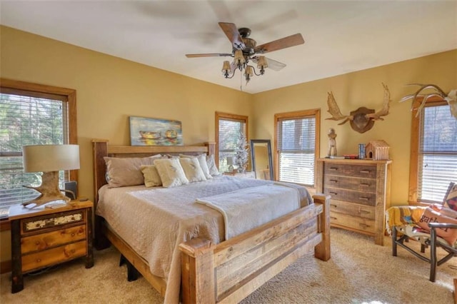 bedroom featuring light carpet and a ceiling fan