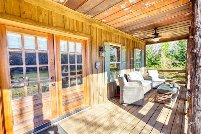 sunroom / solarium featuring wood ceiling and ceiling fan