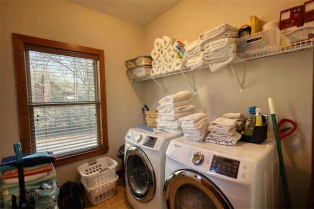 washroom featuring laundry area, washer and clothes dryer, and tile patterned flooring