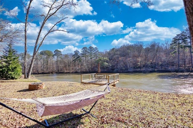 dock area featuring a water view and a wooded view