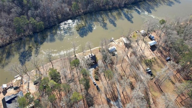 drone / aerial view featuring a water view and a forest view