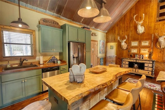 kitchen featuring butcher block countertops, a sink, wood ceiling, green cabinets, and appliances with stainless steel finishes