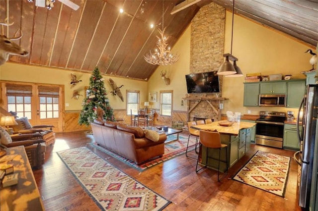 living room with a wainscoted wall, wooden ceiling, and dark wood finished floors