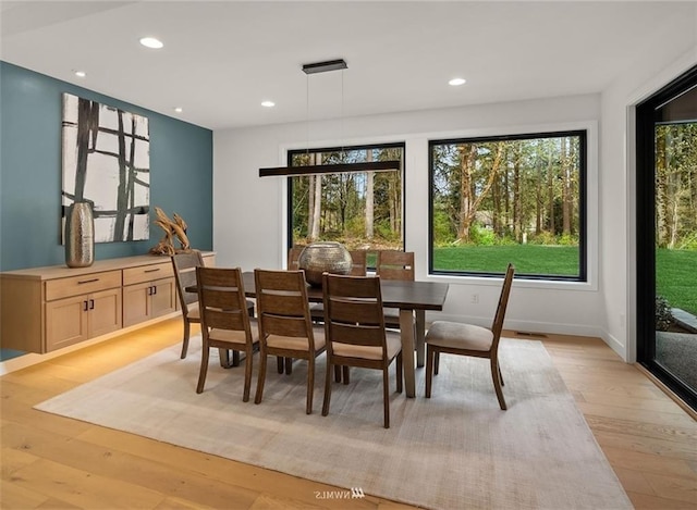 dining space with light wood-type flooring