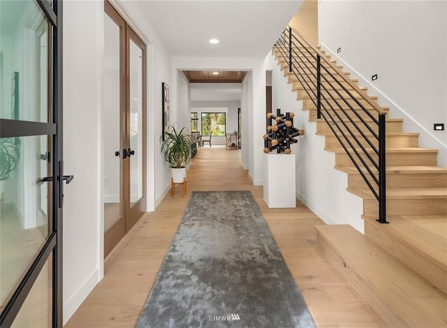 foyer entrance with french doors and light wood-type flooring