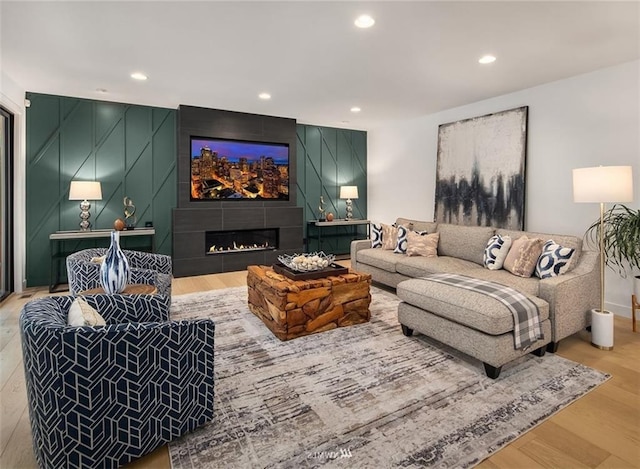 living room featuring hardwood / wood-style flooring and a tiled fireplace