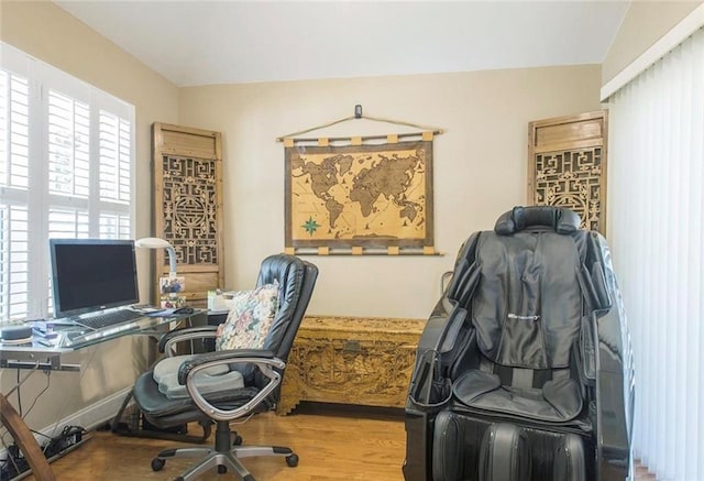 office space featuring wood-type flooring and vaulted ceiling