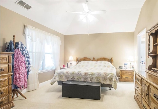 bedroom with ceiling fan, light colored carpet, and vaulted ceiling