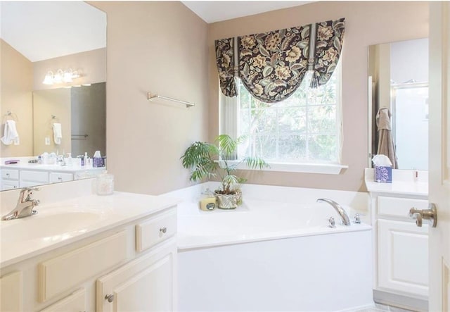 bathroom featuring vanity and a bath