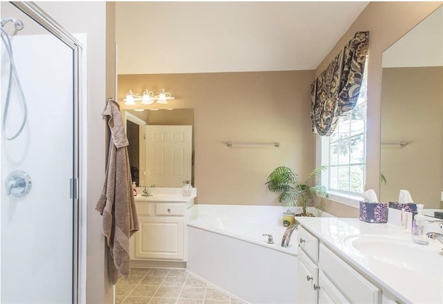 bathroom featuring vanity and independent shower and bath