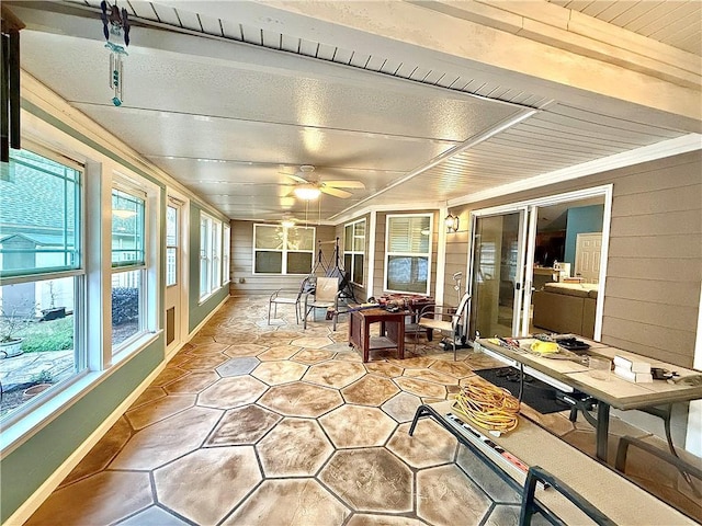 sunroom / solarium featuring ceiling fan