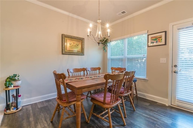 dining room with an inviting chandelier, crown molding, and dark hardwood / wood-style floors