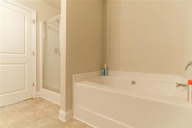 bathroom with independent shower and bath and tile patterned flooring