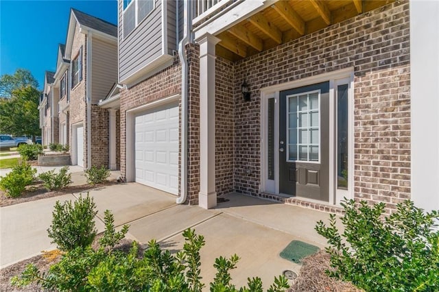 doorway to property with a garage