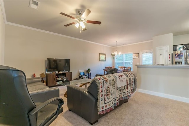 living room featuring ceiling fan with notable chandelier, ornamental molding, and light colored carpet