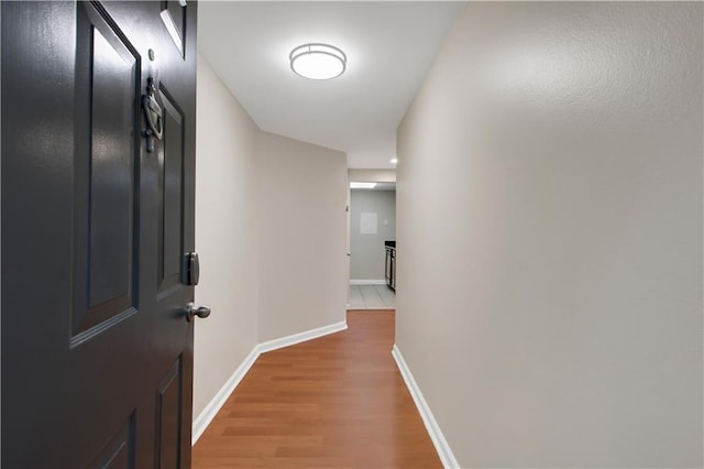 corridor with wood-type flooring