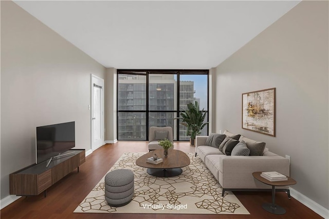 living room featuring dark wood-type flooring and expansive windows