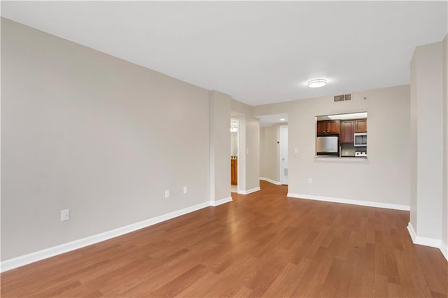 unfurnished living room featuring hardwood / wood-style floors