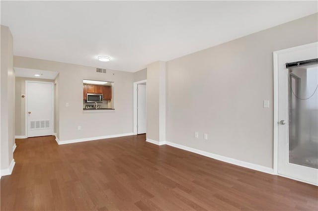 spare room featuring dark hardwood / wood-style floors