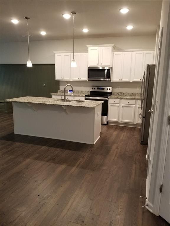 7298 Rockhouse Rd Unit 5, Austell, GA 30168 - kitchen featuring stainless steel appliances, a sink, white cabinetry, light stone counters, and hanging light fixtures