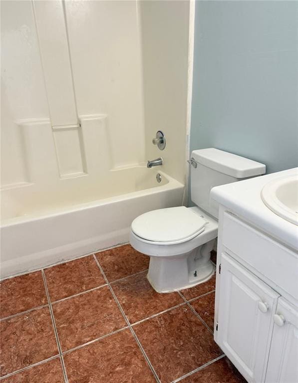 bathroom featuring toilet, vanity, tile patterned floors, and shower / tub combination