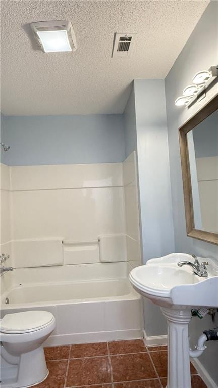 bathroom with  shower combination, toilet, a textured ceiling, and tile patterned flooring