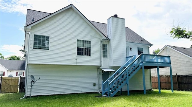 back of house with stairway, a deck, a chimney, and roof with shingles