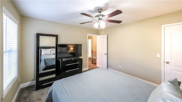 carpeted bedroom with ceiling fan and multiple windows