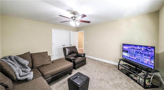 carpeted living room with ceiling fan