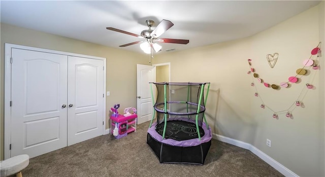 carpeted bedroom featuring a closet and ceiling fan