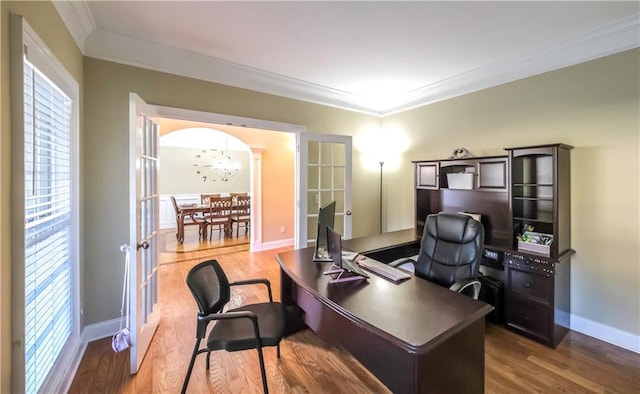 home office with french doors, ornamental molding, and hardwood / wood-style flooring