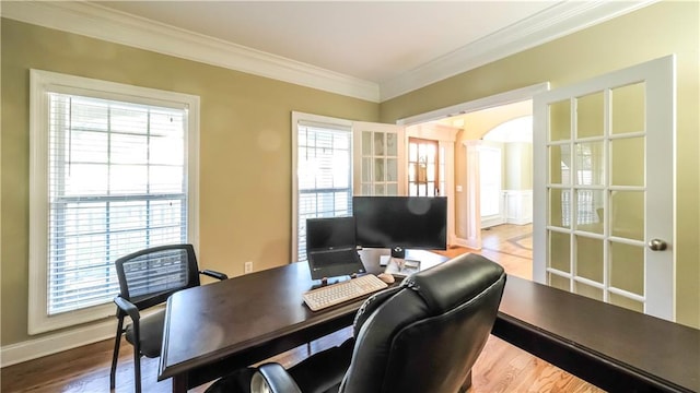 home office featuring french doors, crown molding, hardwood / wood-style flooring, and plenty of natural light