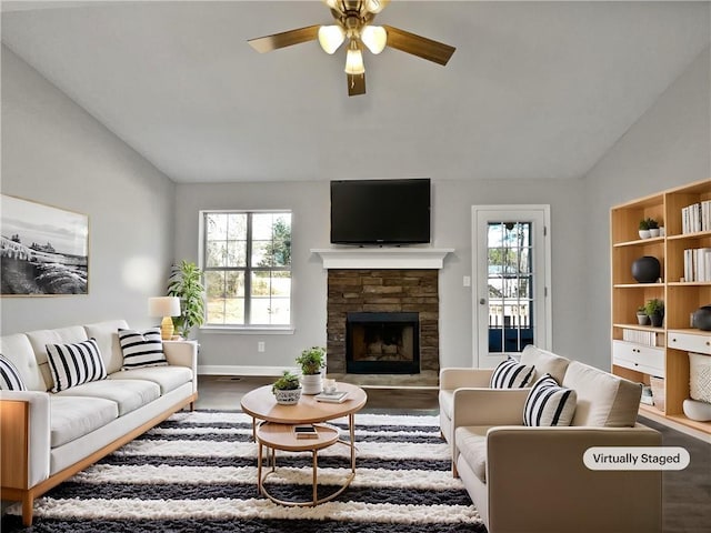 living room featuring a wealth of natural light, vaulted ceiling, and wood-type flooring