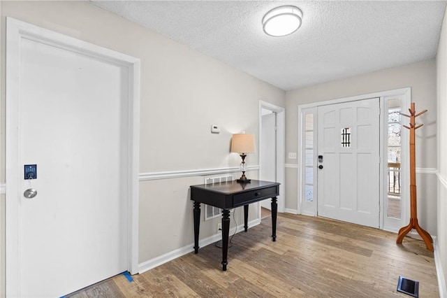 3595 S St NW, Duluth, GA 30096 - entryway featuring wood finished floors, a textured ceiling, and baseboards