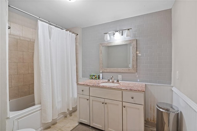 3595 S St NW, Duluth, GA 30096 - bathroom featuring shower / bath combo with shower curtain, vanity, a wainscoted wall, and tile patterned floors