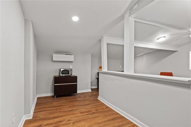 3595 S St NW, Duluth, GA 30096 - hallway with a wall unit AC, wood finished floors, baseboards, and recessed lighting