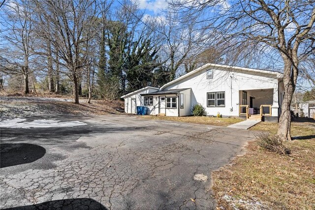 3595 S St NW, Duluth, GA 30096 - view of side of home featuring asphalt driveway and covered porch