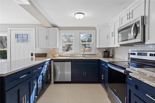 3595 S St NW, Duluth, GA 30096 - kitchen featuring appliances with stainless steel finishes, a sink, plenty of natural light, and blue cabinetry