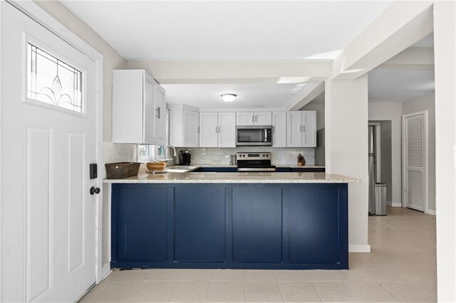 3595 S St NW, Duluth, GA 30096 - kitchen featuring stainless steel appliances, backsplash, a sink, and light tile patterned floors