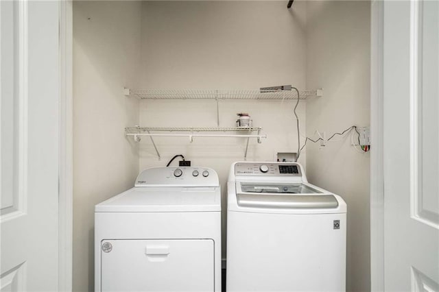 laundry room with laundry area and washing machine and clothes dryer