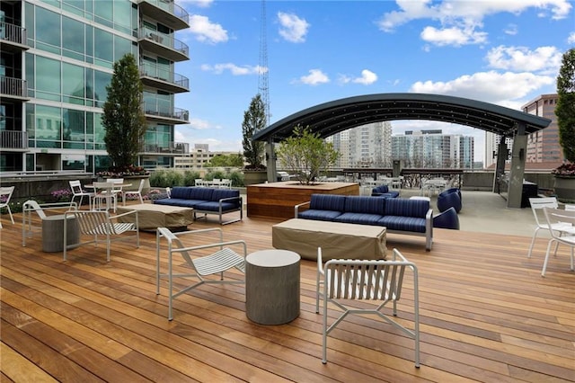 wooden deck with outdoor lounge area, a gazebo, and a view of city