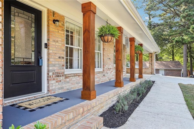 view of exterior entry with covered porch