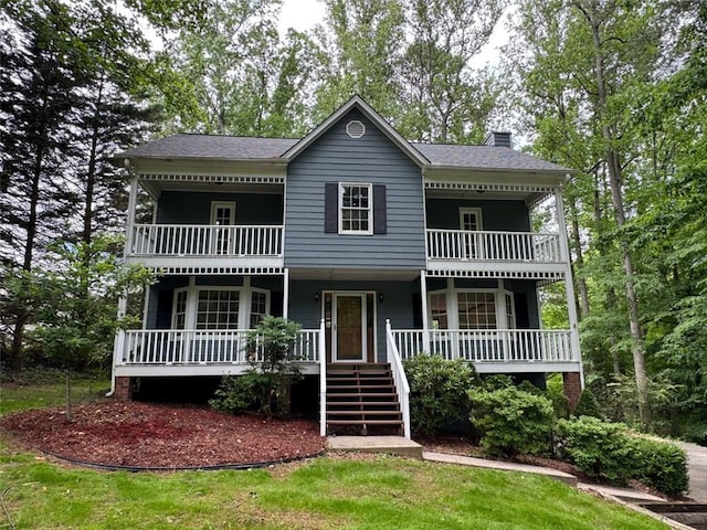 5307 Red Rock Trce, Powder Springs, GA 30127 - view of front of house featuring a balcony, a chimney, covered porch, and stairs