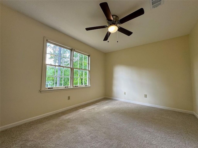 carpeted spare room with baseboards and ceiling fan