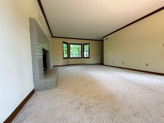 unfurnished living room with ornamental molding, light carpet, a fireplace, and baseboards